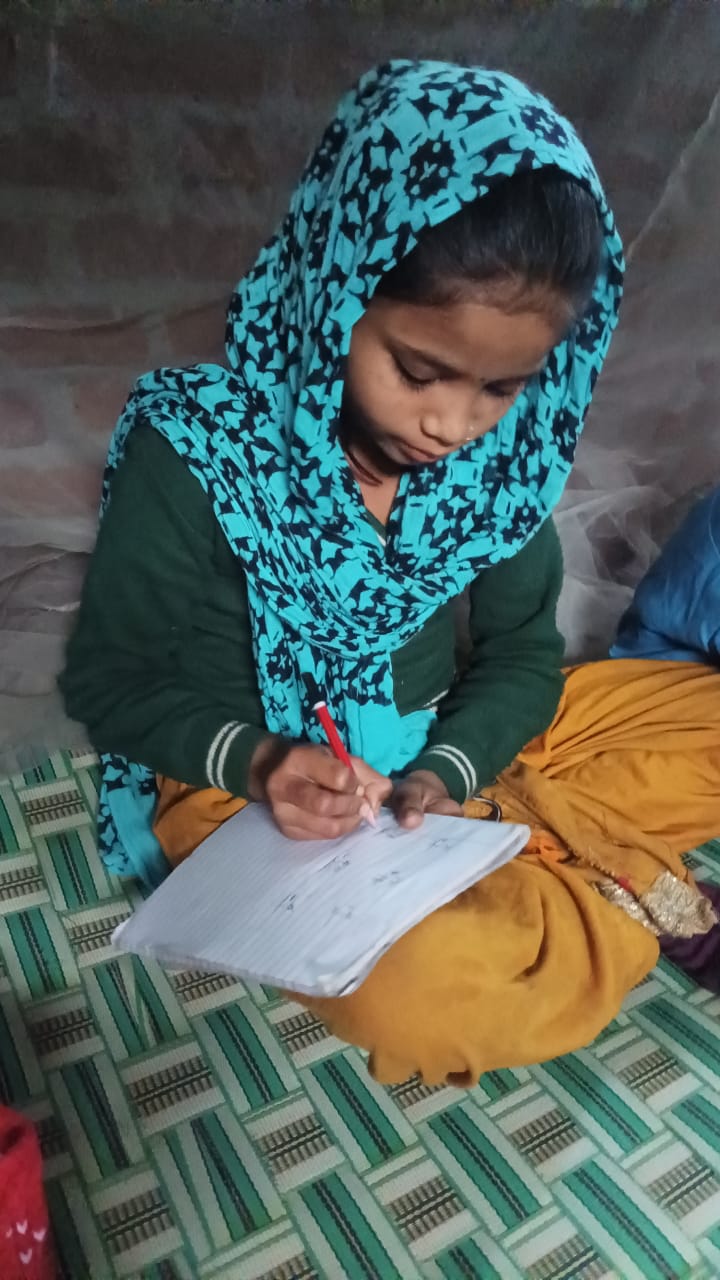 Dolly and Jagriti teaching basic letters